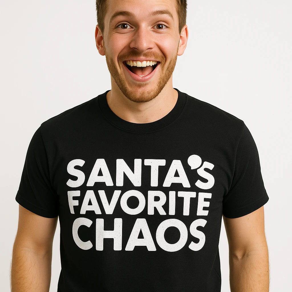Close-up of the "Santas Favorite Chaos" white print on a premium Bella+Canvas black christmas tees