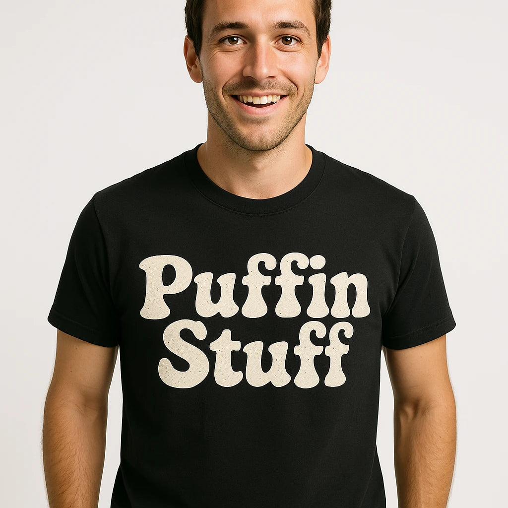 Close-up of the "Puffin Stuff" cream print on a premium Bella+Canvas black birdwatching t shirt