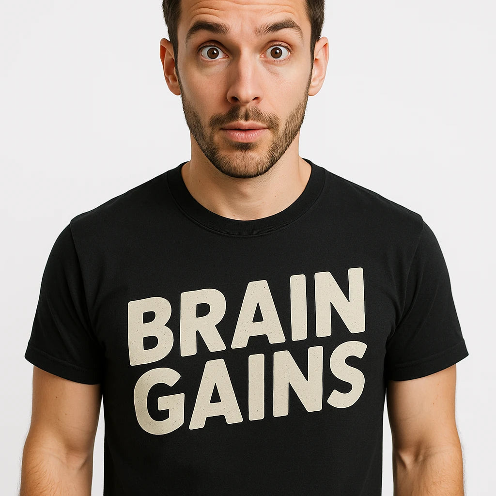 Close-up of the "Brain Gains" beige print on a premium Bella+Canvas black studying t shirt
