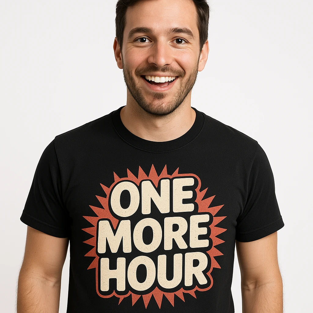 Close-up of the "One More Hour" beige print on a premium Bella+Canvas black new years shirts