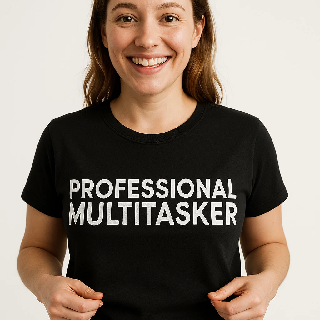 Close-up of the "Professional Multitasker" white print on a premium Bella+Canvas black mom life graphic tees