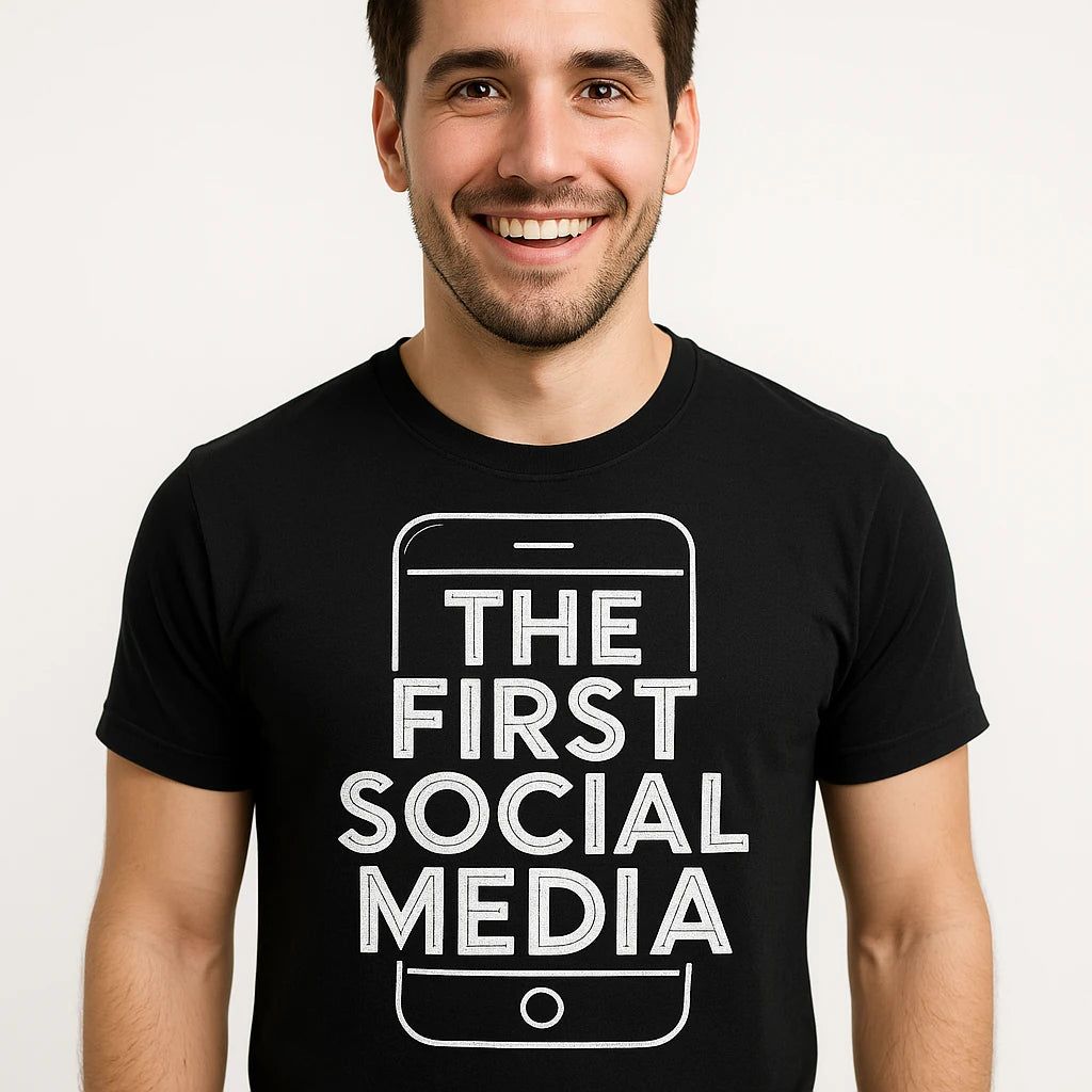Close-up of the "The First Social Media" white print on a premium Bella+Canvas black smartphone t shirt