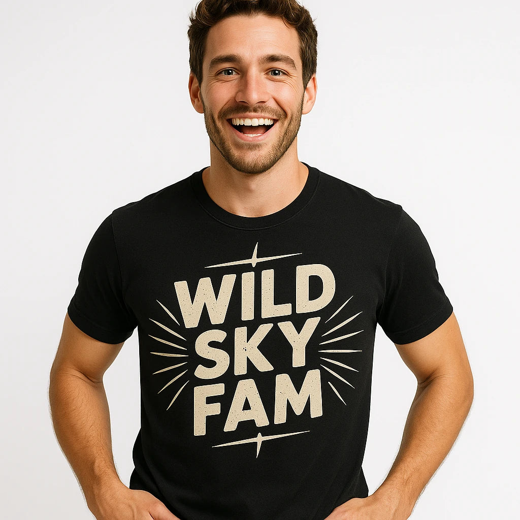 Close-up of the "Wild Sky Fam" beige print on a premium Bella+Canvas black storms t shirt