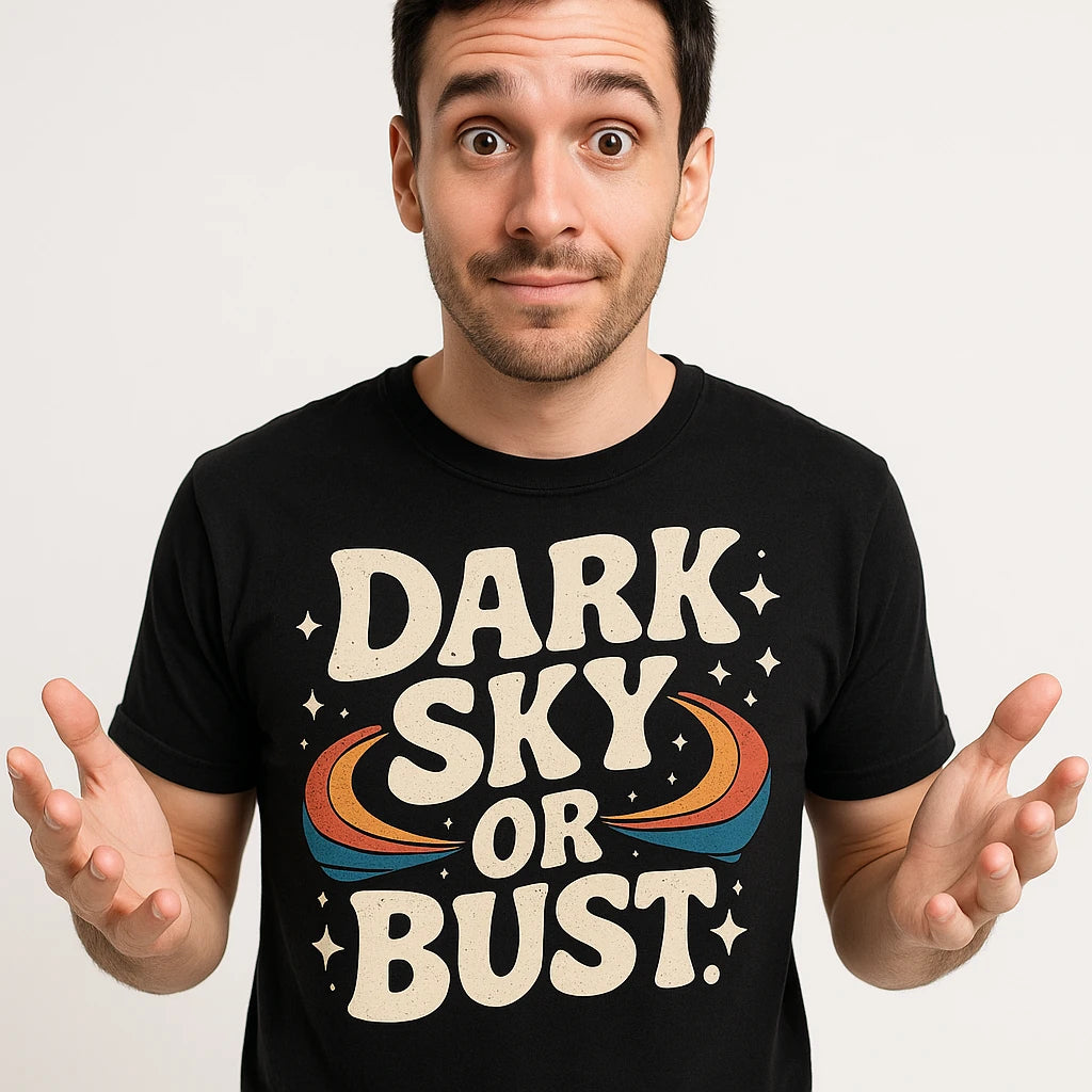 Close-up of the "Dark Sky Or Bust" beige print on a premium Bella+Canvas black stargazing t shirt