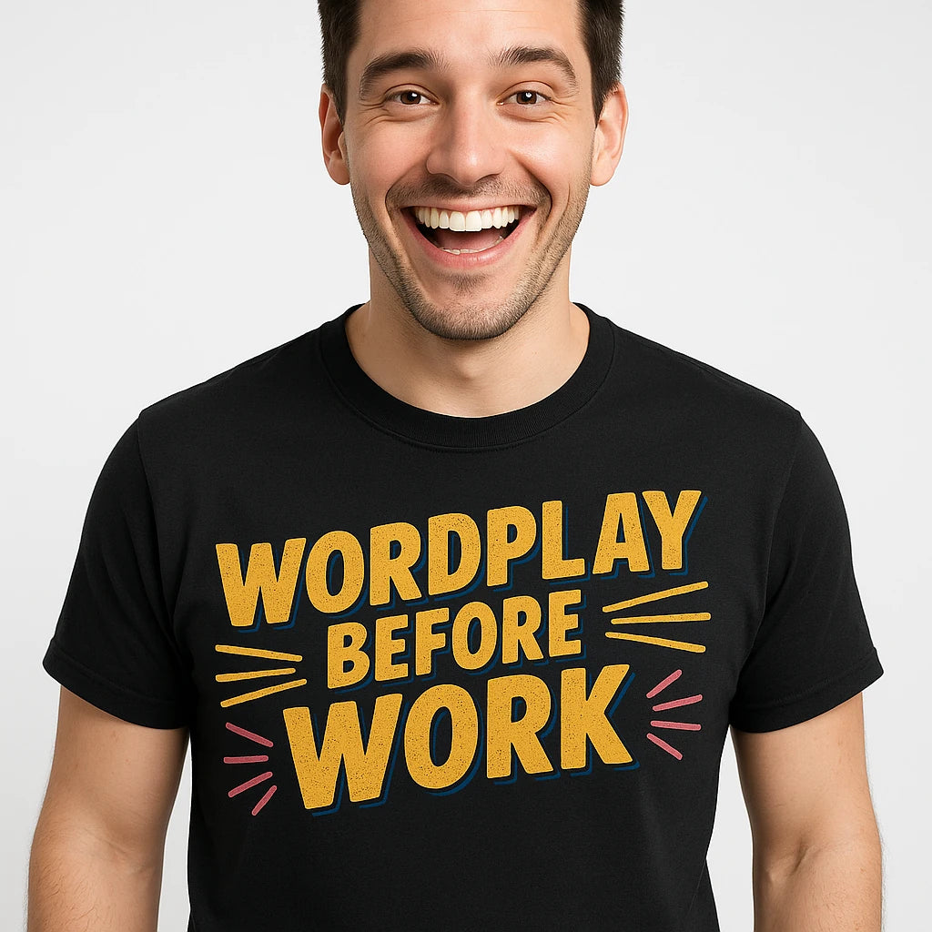 Close-up of the "Wordplay Before Work" yellow print on a premium Bella+Canvas black comedy t shirt