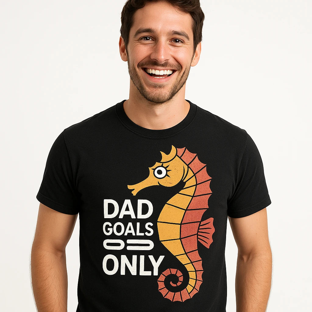 Close-up of the "Dad Goals Only" orange print on a premium Bella+Canvas black seahorse t shirt