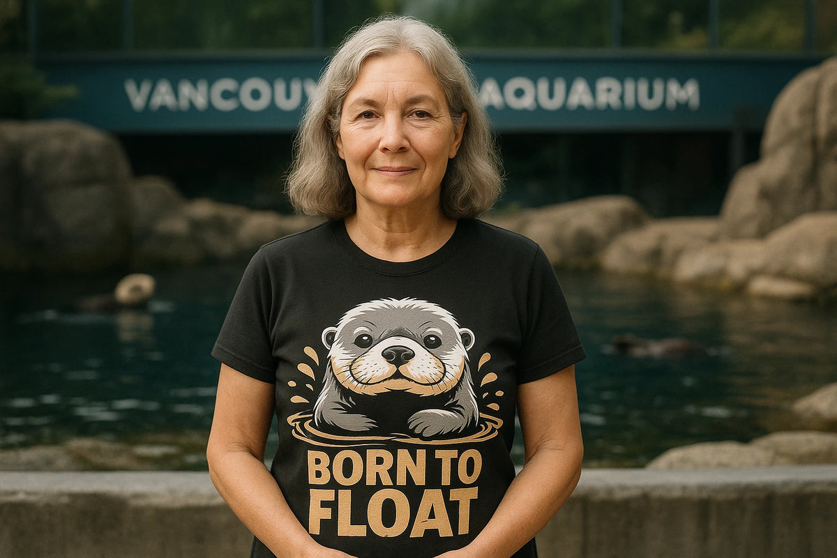 Lifestyle shot of the "Born To Float" black sea otter t shirt in a real-world setting
