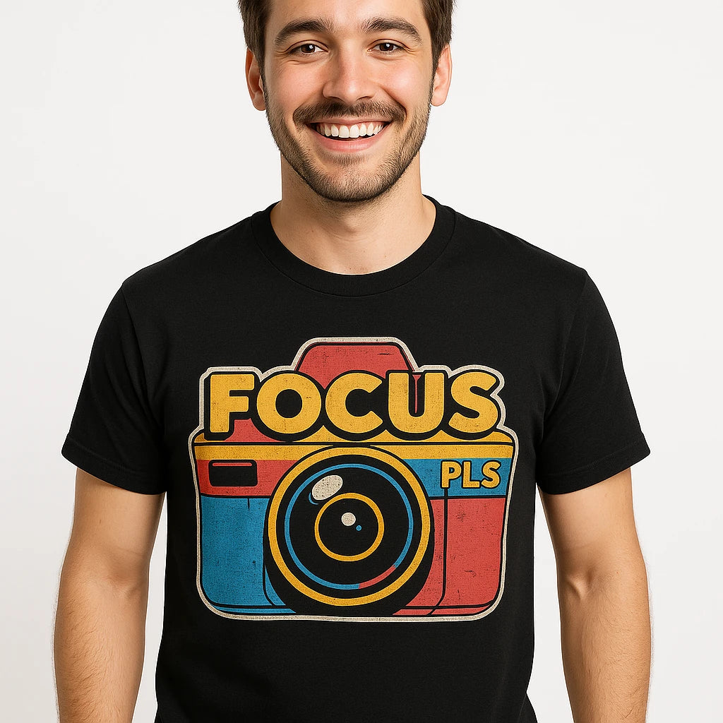 Close-up of the "Focus Pls" orange print on a premium Bella+Canvas black photography on t shirts