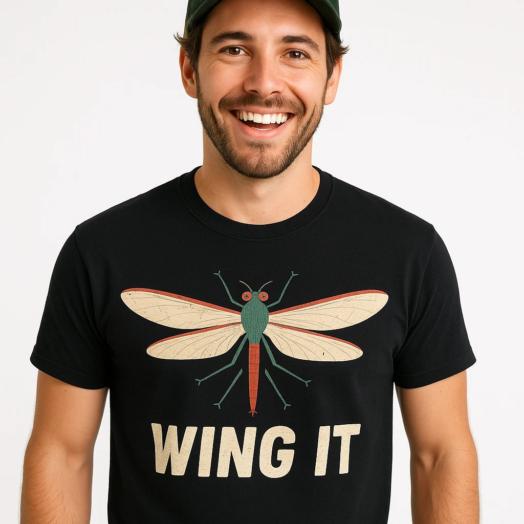 Close-up of the "Wing It" beige print on a premium Bella+Canvas black mayfly t shirt