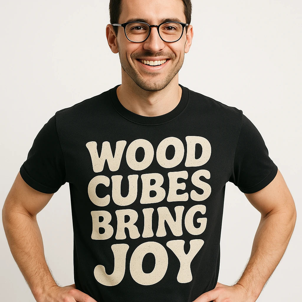 Close-up of the "Wood Cubes Bring Joy" beige print on a premium Bella+Canvas black board game tee shirts