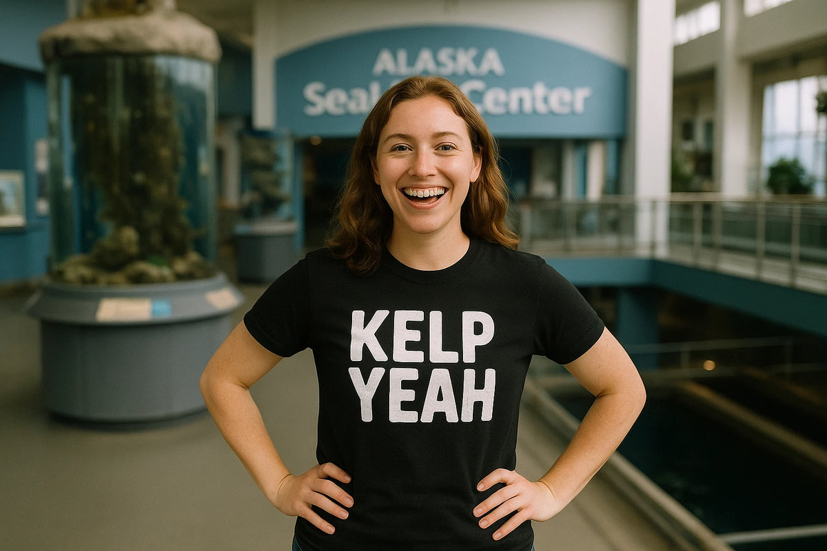Lifestyle shot of the "Kelp Yeah" black sea otter shirts in a real-world setting