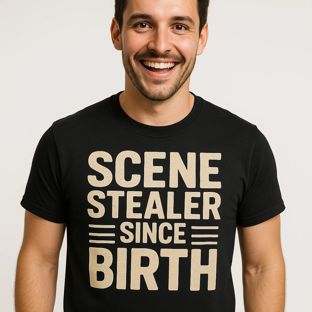 Close-up of the "Scene Stealer Since Birth" beige print on a premium Bella+Canvas black actor shirts