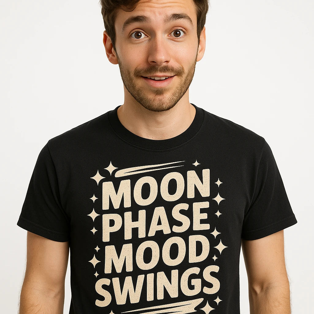 Close-up of the "Moon Phase Mood Swings" beige print on a premium Bella+Canvas black stargazing t shirt