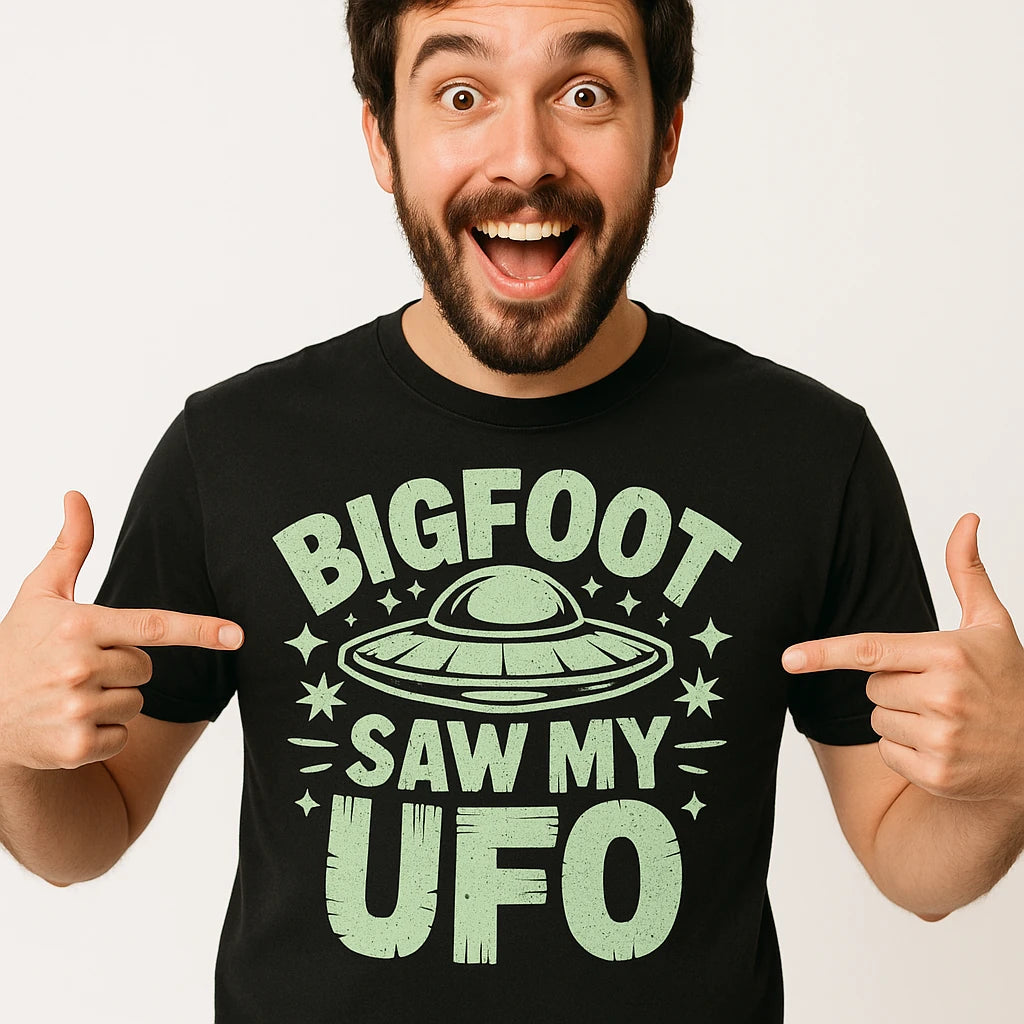 Close-up of the "Bigfoot Saw My UFO" light gray print on a premium Bella+Canvas black alien tee shirts