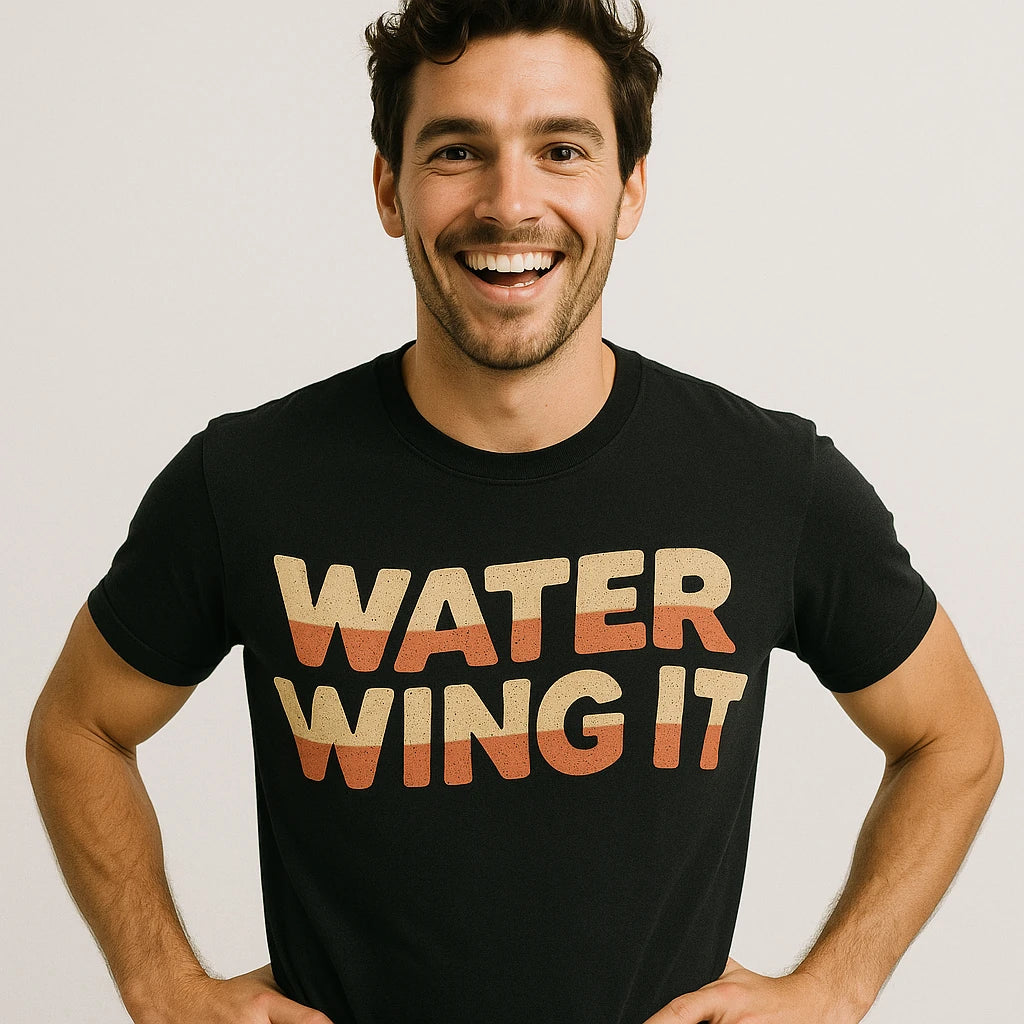 Close-up of the "Water Wing It" tan print on a premium Bella+Canvas black sun protection shirts for swimming