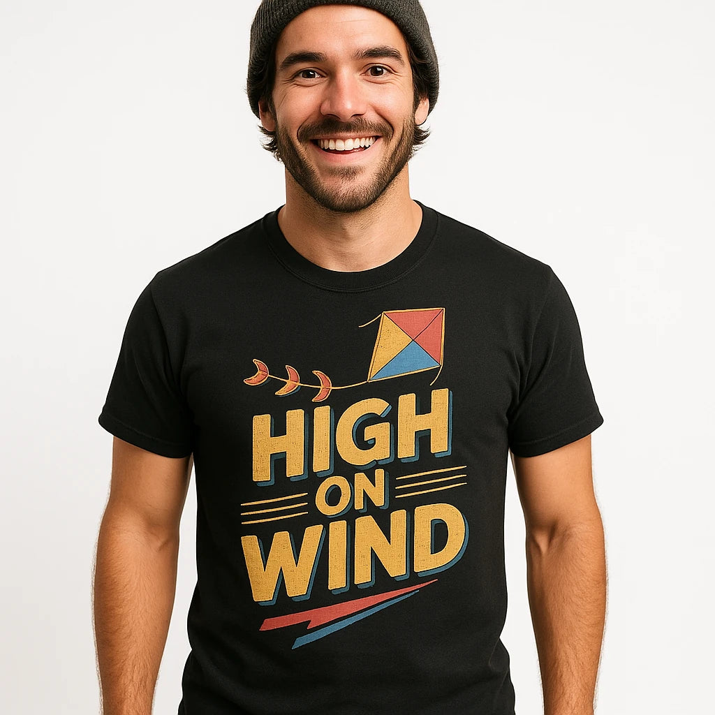 Close-up of the "High on Wind" gold print on a premium Bella+Canvas black kite flying t shirt