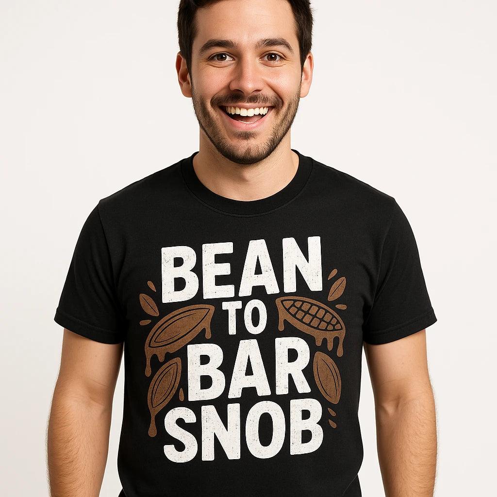 Close-up of the "Bean To Bar Snob" white print on a premium Bella+Canvas black chocolate t shirt