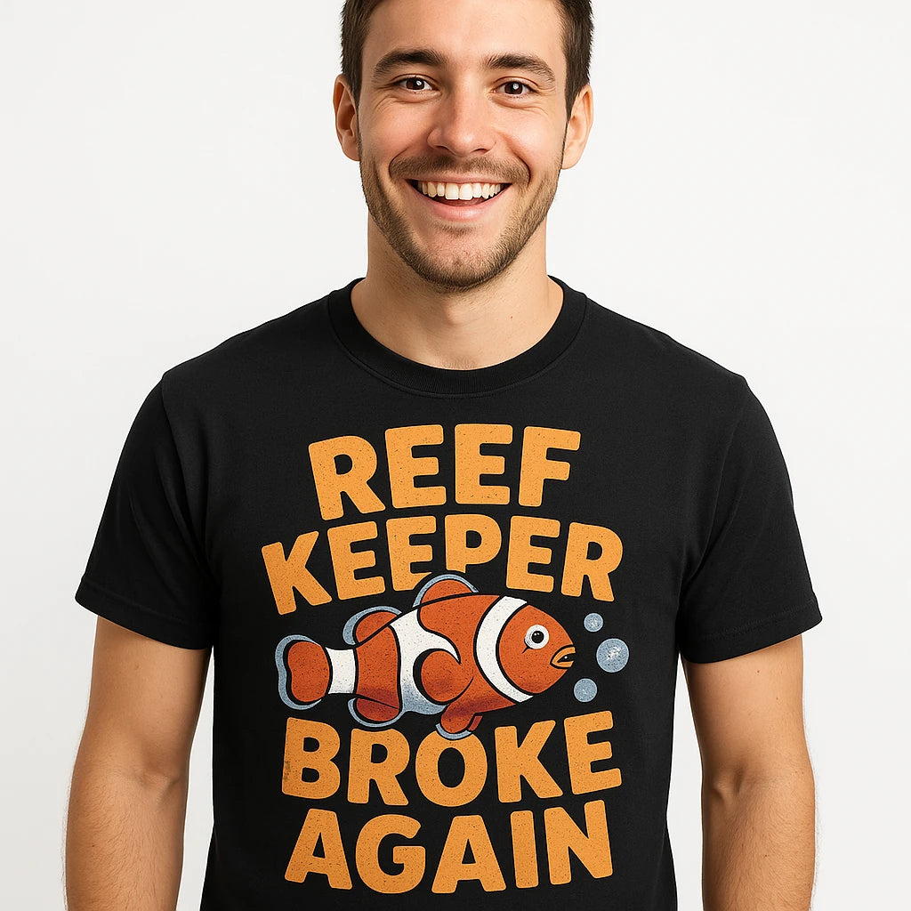 Close-up of the "Reef Keeper Broke Again" gold print on a premium Bella+Canvas black clownfish shirts