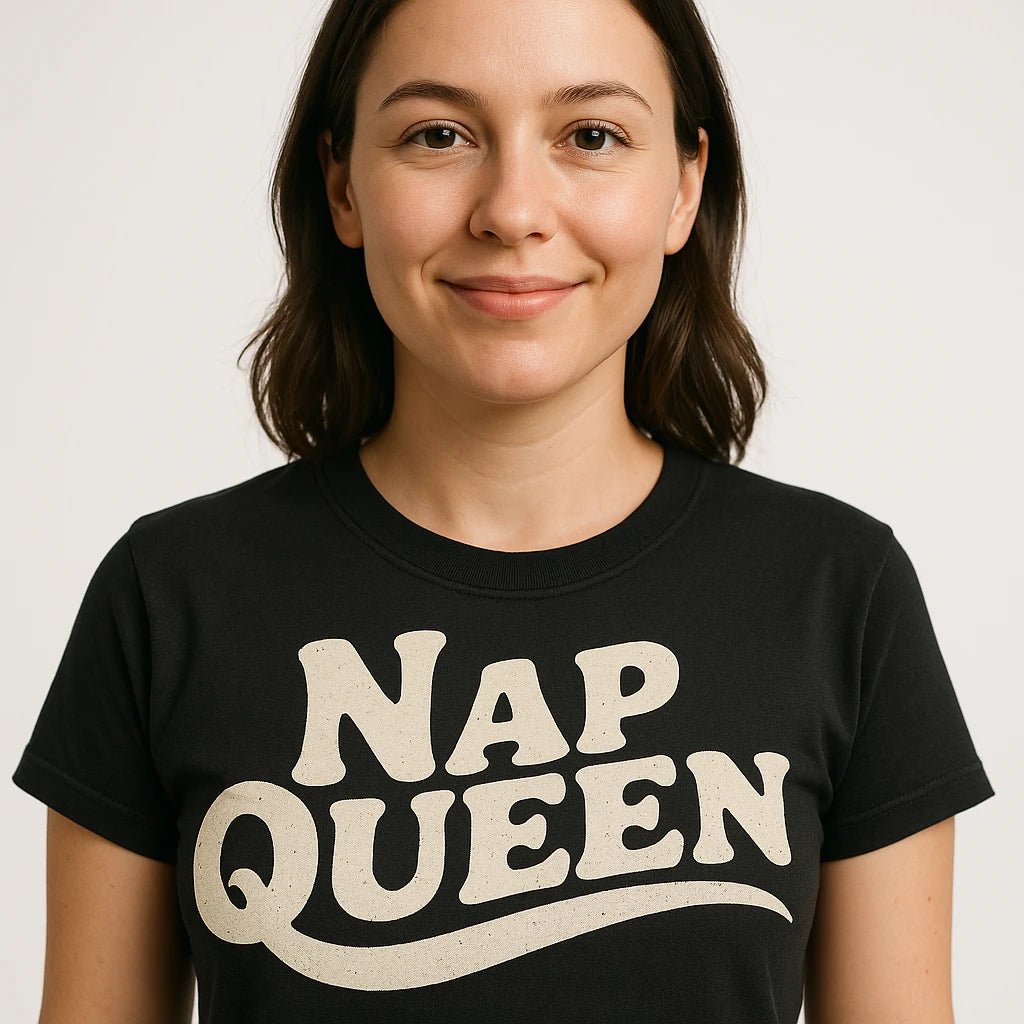 Close-up of the "Nap Queen" cream print on a premium Bella+Canvas black relaxing t shirt