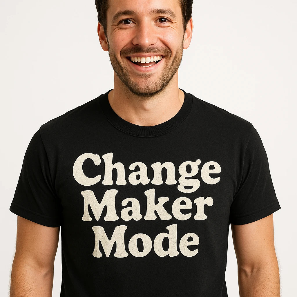 Close-up of the "Change Maker Mode" beige print on a premium Bella+Canvas black activism shirts