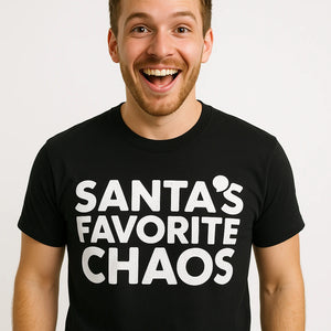 Close-up of the "Santas Favorite Chaos" white print on a premium Bella+Canvas black christmas tees