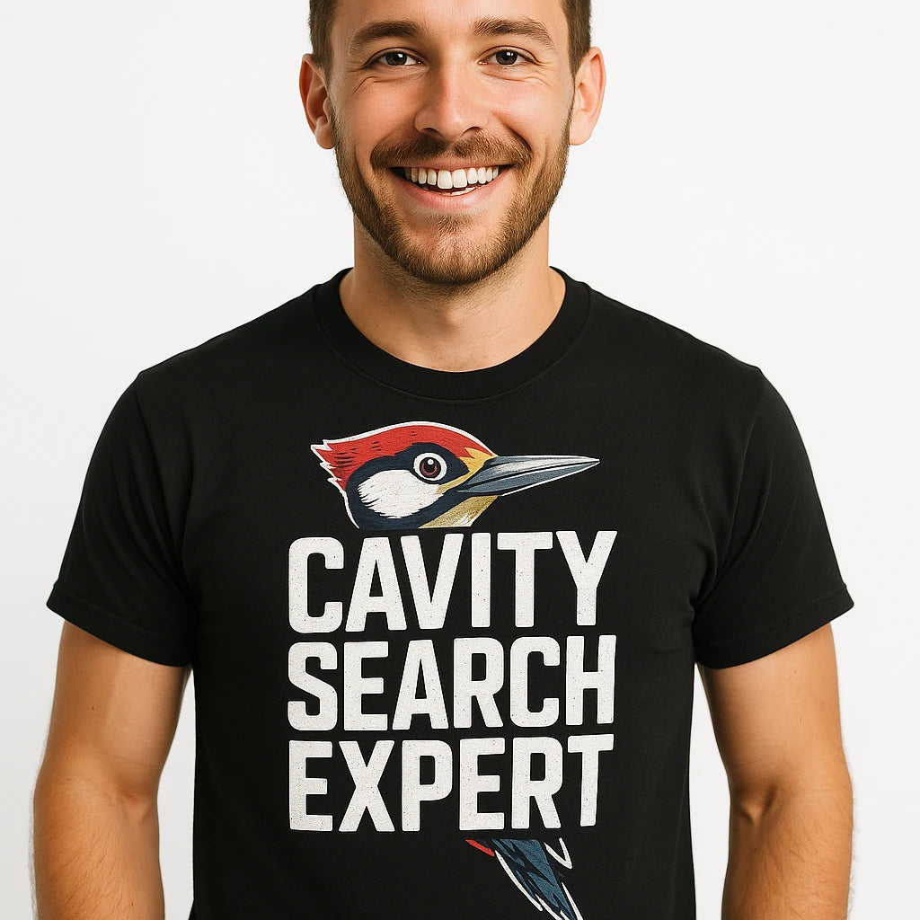 Close-up of the "Cavity Search Expert" white print on a premium Bella+Canvas black woodpecker shirts