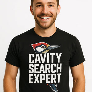 Close-up of the "Cavity Search Expert" white print on a premium Bella+Canvas black woodpecker shirts