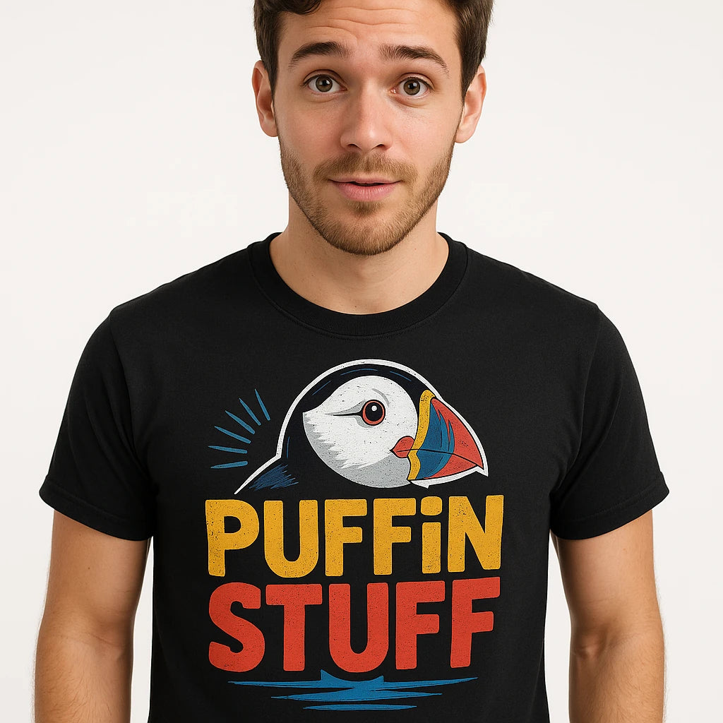 Close-up of the "Puffin Stuff" gold print on a premium Bella+Canvas black bird watching t shirt