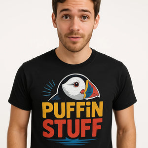 Close-up of the "Puffin Stuff" gold print on a premium Bella+Canvas black bird watching t shirt