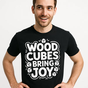 Close-up of the "Wood Cubes Bring Joy" white print on a premium Bella+Canvas black board game shirts