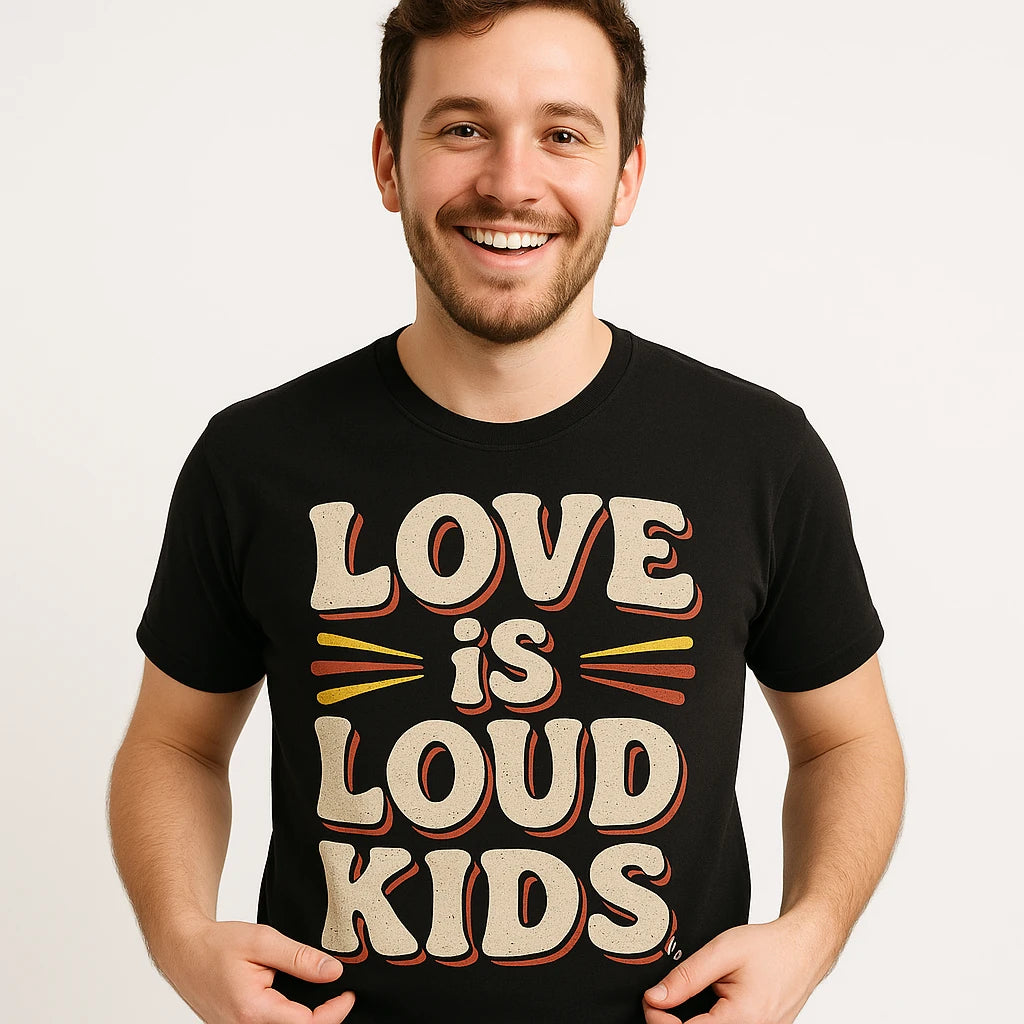 Close-up of the "Love Is Loud Kids" beige print on a premium Bella+Canvas black family life t shirt