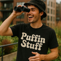 A person wearing a black bucket hat and a black t-shirt with the text 