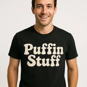 Close-up of the "Puffin Stuff" cream print on a premium Bella+Canvas black birdwatching t shirt