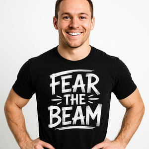Close-up of the "Fear the Beam" white print on a premium Bella+Canvas black gymnastics t shirt