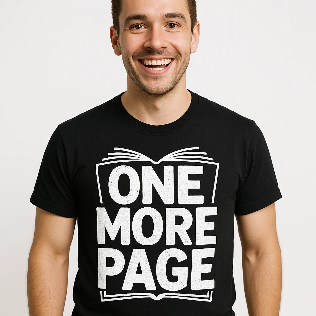 Close-up of the "One More Page" white print on a premium Bella+Canvas black reading tee shirts