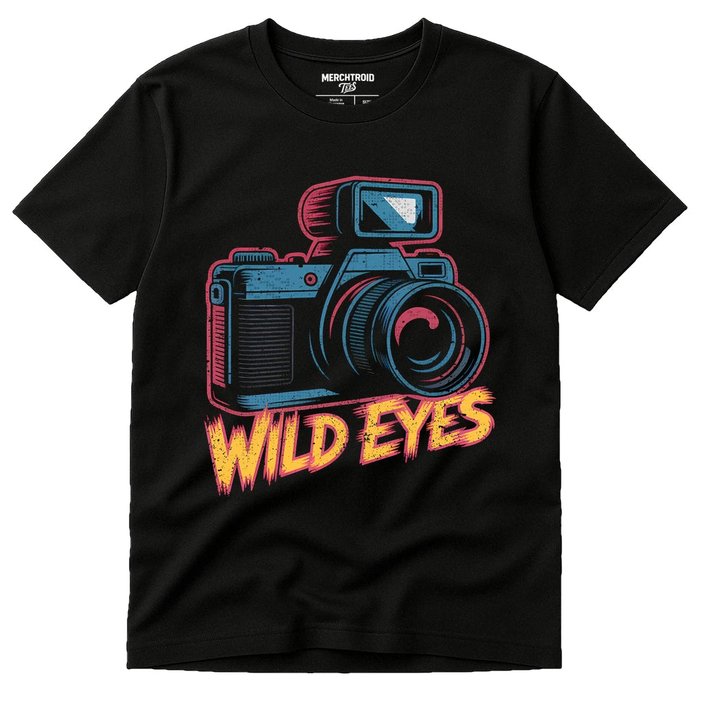 A black t-shirt featuring a colorful graphic of a vintage camera with the text "WILD EYES" in a bold, stylized font underneath.