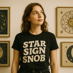 Lifestyle shot of the "Star Sign Snob" black astrology tee shirts in a real-world setting