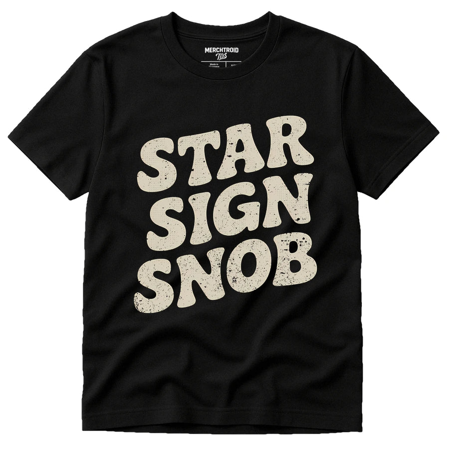 A black T-shirt with a bold, vintage-style font in off-white that reads "STAR SIGN SNOB." The shirt has a casual design and appears to be made of cotton.