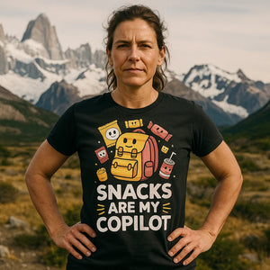 Lifestyle shot of the "Snacks Are My Copilot" black adventure tshirt in a real-world setting
