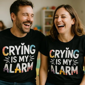 Person wearing the black new parents shirts graphic tee - "Crying Is My Alarm" design