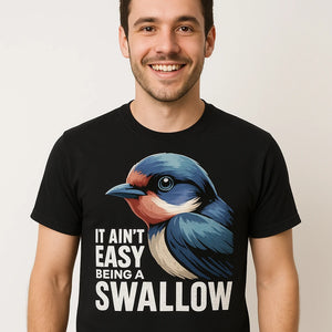 Close-up of the "It Ain'T Easy Being a Swallow" gray print on a premium Bella+Canvas black t shirt i swallow