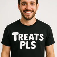 A smiling person with short dark hair and a beard, wearing a black t-shirt with the text 