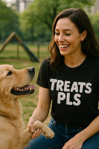 A person with long dark hair is smiling and wearing a black t-shirt with white text that reads 