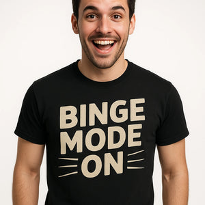 Close-up of the "Binge Mode On" beige print on a premium Bella+Canvas black graphic tee