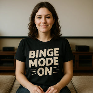 Lifestyle shot of the "Binge Mode On" black graphic tee in a real-world setting