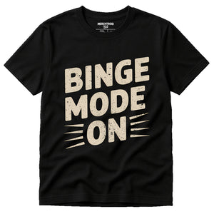 Black Graphic Tee - "Binge Mode On" graphic tee with beige print, flat lay product photo