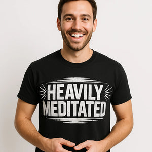 Close-up of the "Heavily Meditated" white print on a premium Bella+Canvas black meditation t shirt