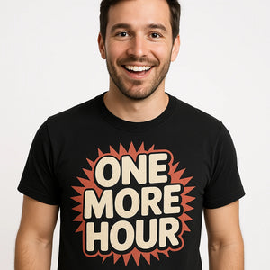 Close-up of the "One More Hour" beige print on a premium Bella+Canvas black new years shirts