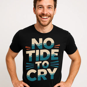 Close-up of the "No Tide To Cry" beige print on a premium Bella+Canvas black oceans t shirt