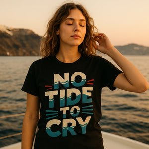 Lifestyle shot of the "No Tide To Cry" black oceans t shirt in a real-world setting